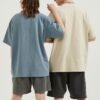 Custom Heavyweight Vintage-Washed Oversized T-Shirt - Style DE8FBB Two models wearing vintage-washed oversized t-shirts