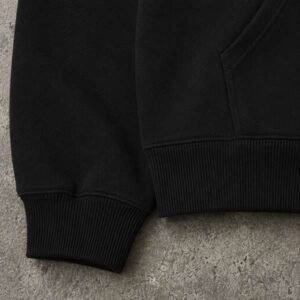 Close-up of a black heavyweight pullover hoodie.