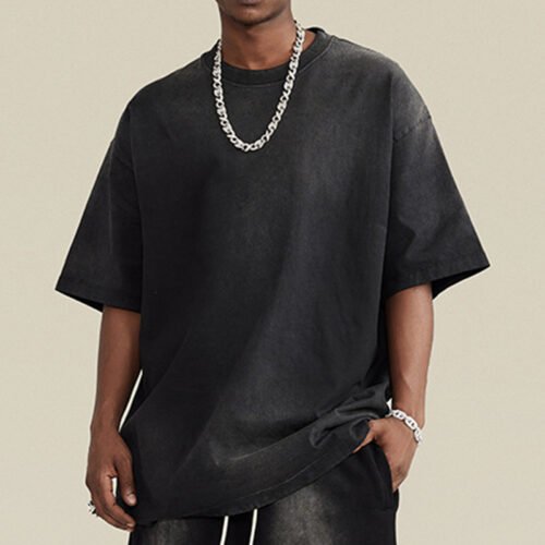 Custom Solid-Color Heavyweight Shorts | - Style C10E88 Black oversized t-shirt with a washed effect, worn by a model with a silver chain.