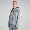 Man wearing a grey hooded windbreaker with neon yellow accents