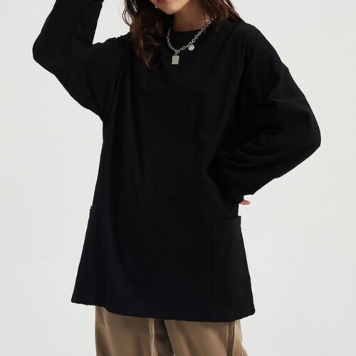 Woman wearing a plain black long sleeve oversized sweatshirt with pockets