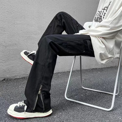 Black loose-fit cargo pants with side zippers and utility pockets.
