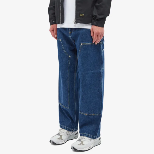 Man wearing loose straight fit blue denim jeans