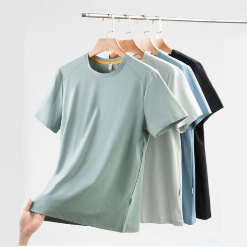 Four quick-dry outdoor t-shirts in different colors hanging on a rack.