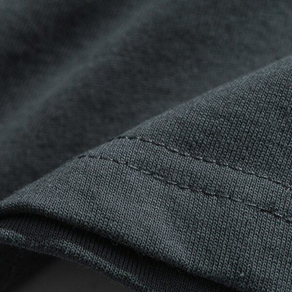Custom Oversized Direct-Print Streetwear T-Shirt - Style 2E8D04 Close-up of the seam and fabric texture of a dark grey t-shirt.