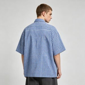 Man wearing a blue and white gingham oversized shirt