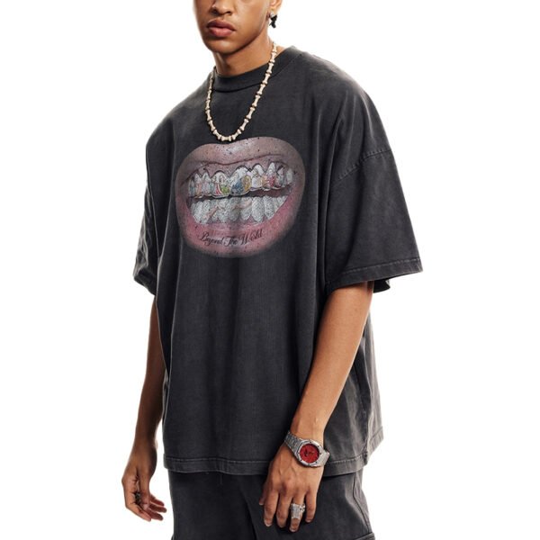 Washed black oversized t-shirt with a graphic of lips and diamond-grillz