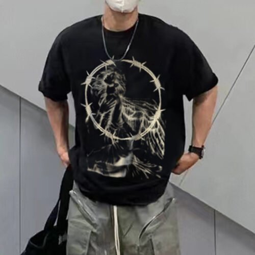 Custom Oversized Graphic T-Shirt - Style 1FDEF6 Man wearing a black oversized t-shirt with a graphic of an angel in barbed wire.