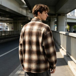 Man wearing a brown and cream plaid oversized long-sleeve shirt