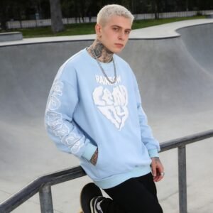 Light blue oversized pullover with puff print graphic on chest and sleeves
