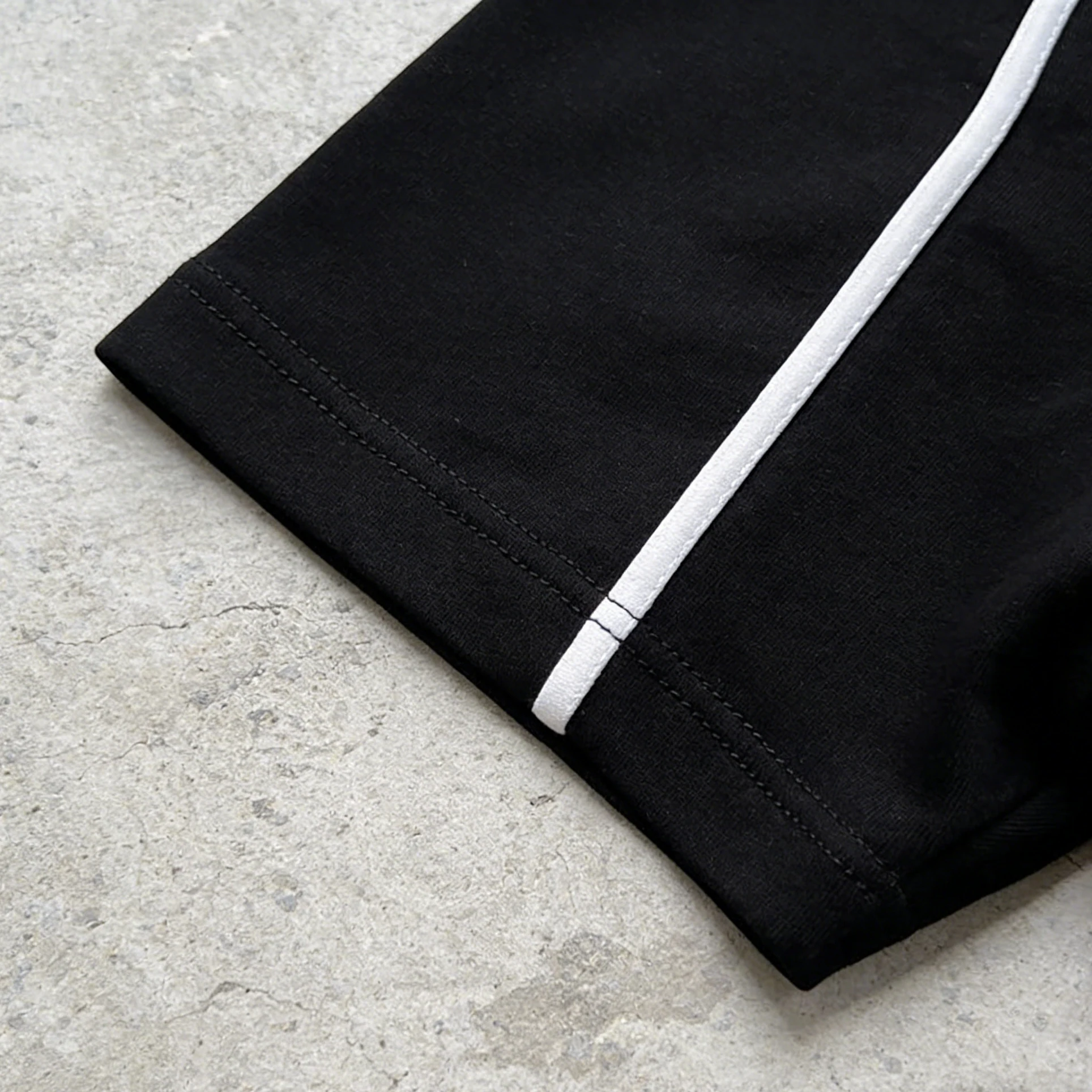 Black piped oversized tracksuit set with white piping detail.