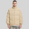 Custom High-Collar Padded Zip Front Coat - Style 49E64A Man wearing a beige high-collar padded zip front coat