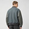 Custom Patch-Spliced Varsity Bomber Jacket - Style 51DBAA Man wearing a grey and dark grey varsity bomber jacket