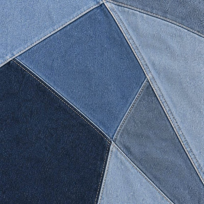 Close-up of a multi-tone denim patchwork canvas jacket.