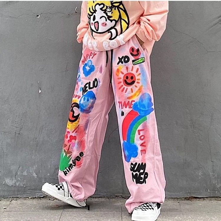 Pink wide-leg pants with colorful graffiti art and text