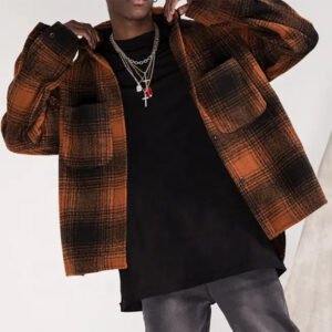 Man wearing an orange and black plaid flannel shirt jacket