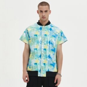 Man wearing a short-sleeve faux-leather varsity jacket with abstract print