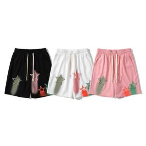 Three pairs of french terry shorts in black, white, and pink with star print