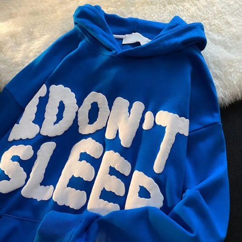 Blue pullover hoodie with raised white text 'I DON'T SLEEP'