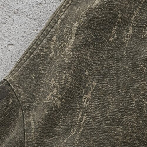 Close-up of a distressed olive green hooded canvas jacket with a textured washed finish.