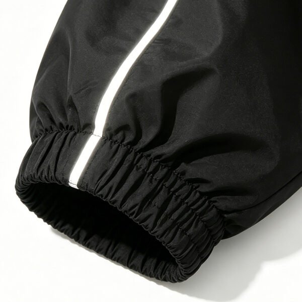Custom Reflective Patchwork Hooded Jacket - Style 98EF81 Close-up of a black jacket sleeve with a reflective stripe