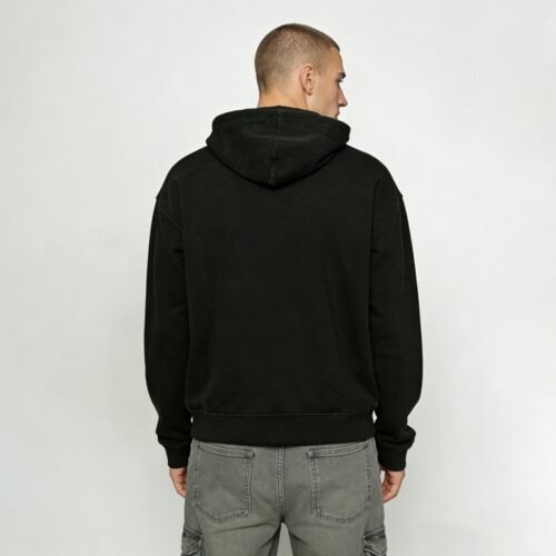 Man wearing a black pullover hoodie from behind