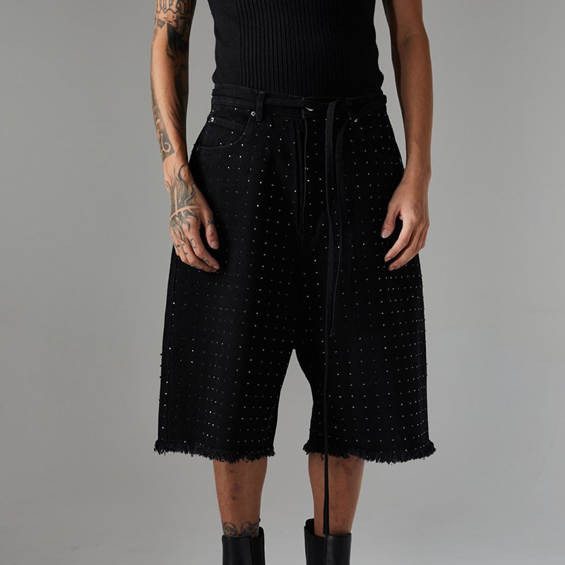 Man wearing black washed denim long shorts with all-over rhinestones