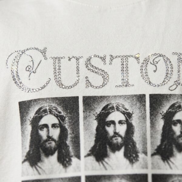 Custom rhinestone crop t-shirt with repeated religious imagery.