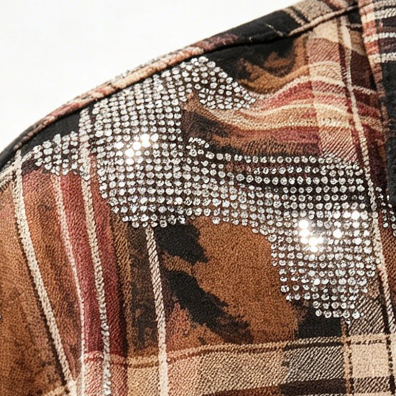 Close-up of a plaid shirt with rhinestone embellishments on the shoulder