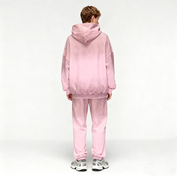 Man wearing a pink ombre hoodie and sweatpants set