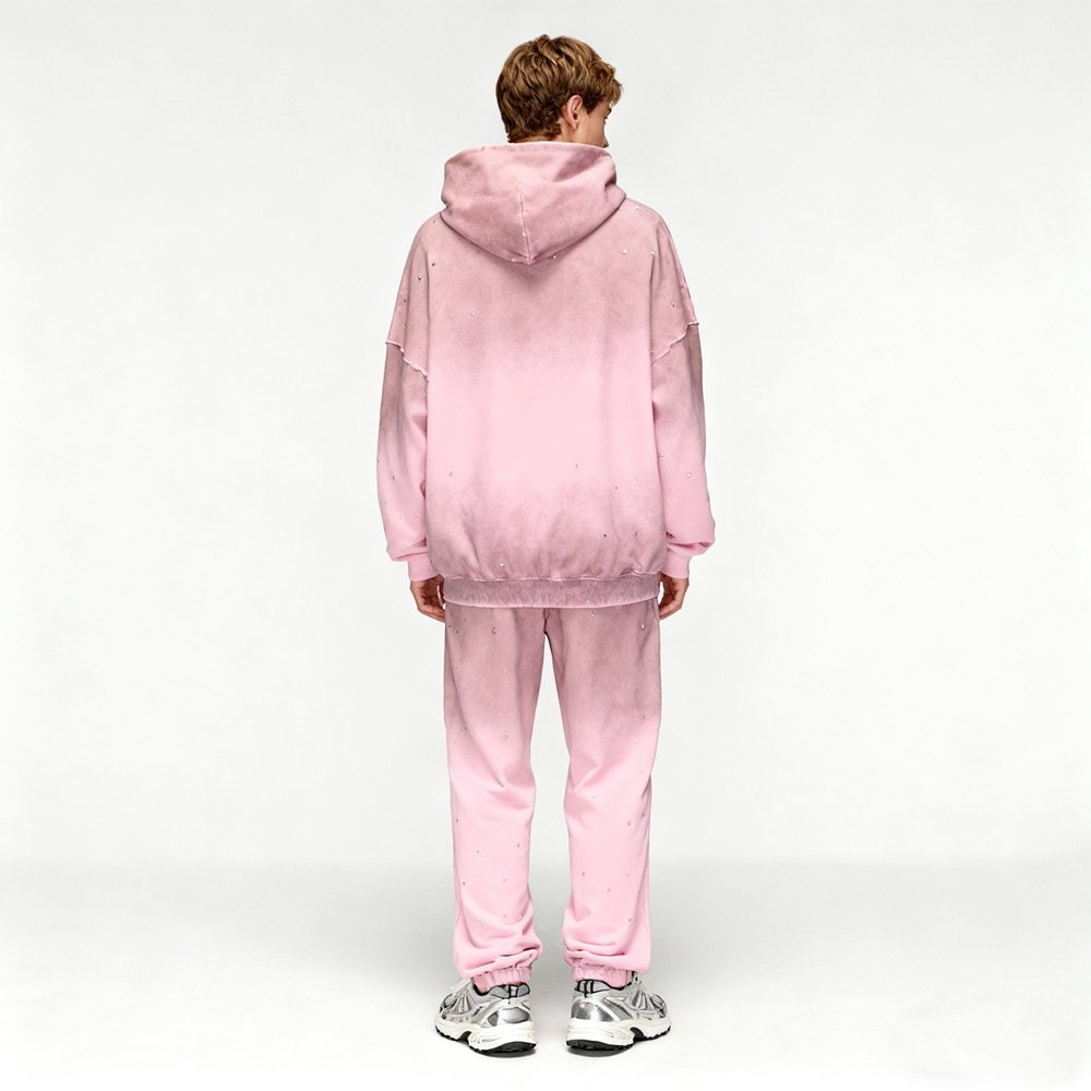 Man wearing a pink ombre hoodie and sweatpants set