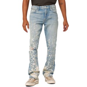 Light wash denim jeans with white splatter print and a ripped knee
