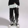 Custom Layered Fray Hem Spliced Denim Jeans - Style DAA382 Layered frayed hem spliced denim jeans with ripped detailing and chain