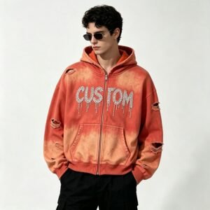 Man wearing an orange spray-dye rhinestone distressed zip hoodie