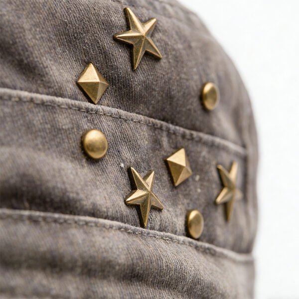 Custom Vintage Washed Studded Flat Cap - Style FD04D0 Close-up of a vintage washed grey flat cap with metal star and pyramid studs.
