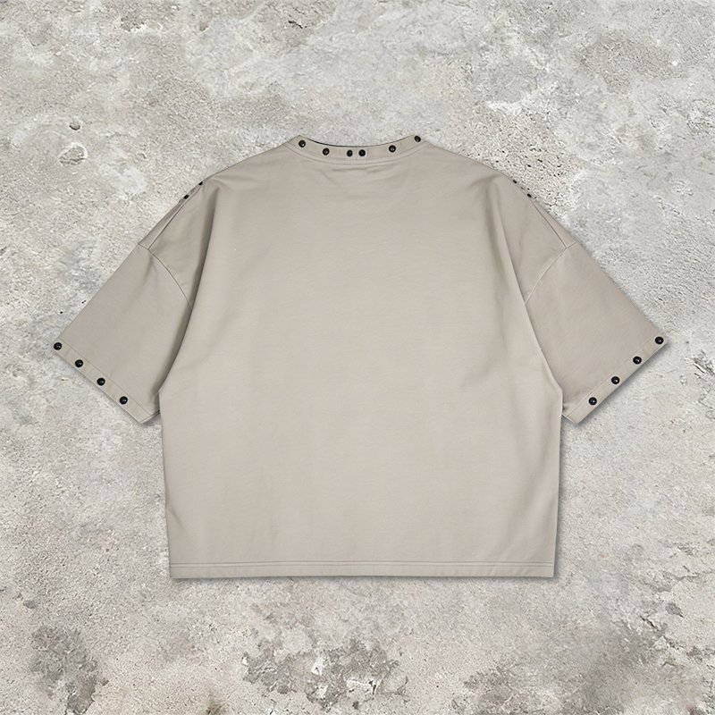 Beige oversized streetwear t-shirt with stud details on collar and sleeves