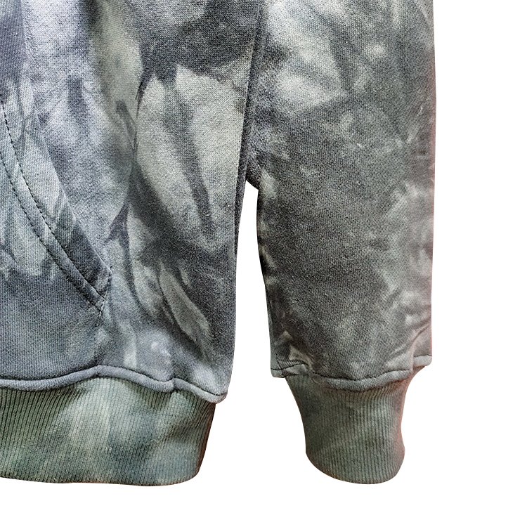 Close-up of a grey tie-dye pullover hoodie sleeve and pocket.
