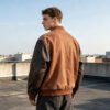 Custom Two-Tone Baseball Jacket 63C-22P-14PU Multi - Style D0D227 Man from behind wearing a brown baseball jacket with dark quilted sleeves