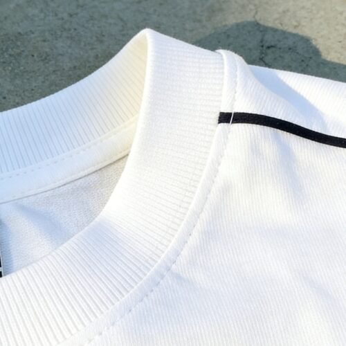 Custom Varsity Front-Zip Bomber Jacket | - Style FF6930 Close-up of a white bomber jacket collar with ribbed texture and a black stripe.
