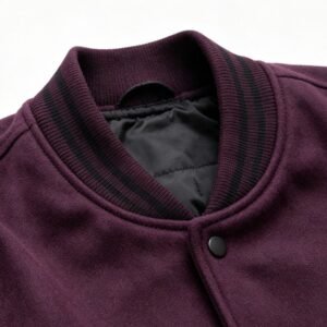 Close-up of a wine red varsity jacket collar with black stripes.