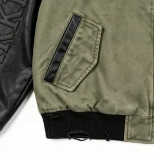 Close-up of a vintage color-block baseball jacket with distressed details.