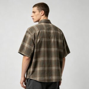 Back view of a man wearing a brown and green plaid short-sleeve shirt