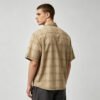 Man wearing a vintage tan plaid short-sleeve shirt