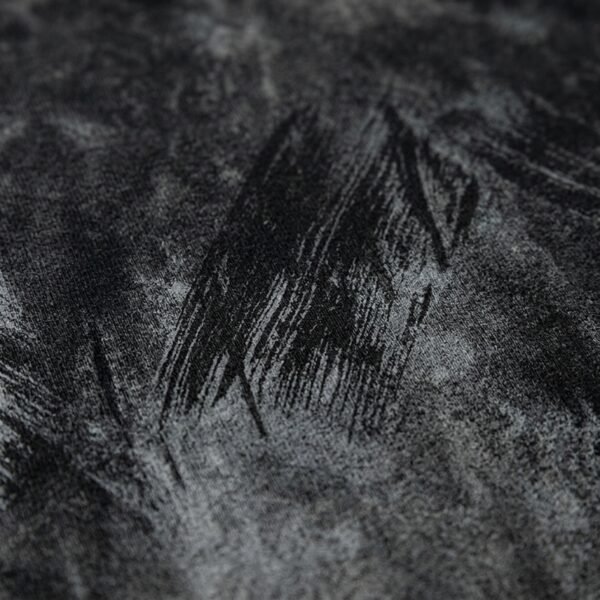 Close-up of a dark grey vintage-washed oversized heavyweight t-shirt with abstract print.