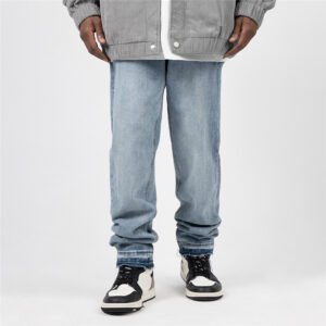Close-up of light wash straight-leg jeans with distressed hems