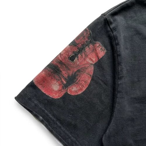 Close-up of a vintage washed t-shirt with a boxing glove graphic