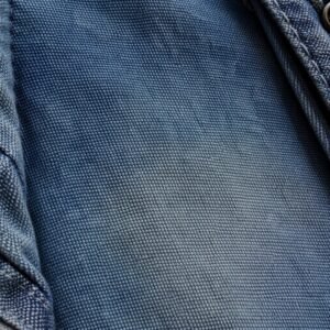 Close-up of blue washed canvas fabric with a denim-like texture.