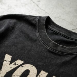 Close-up of a black washed cropped graphic t-shirt.