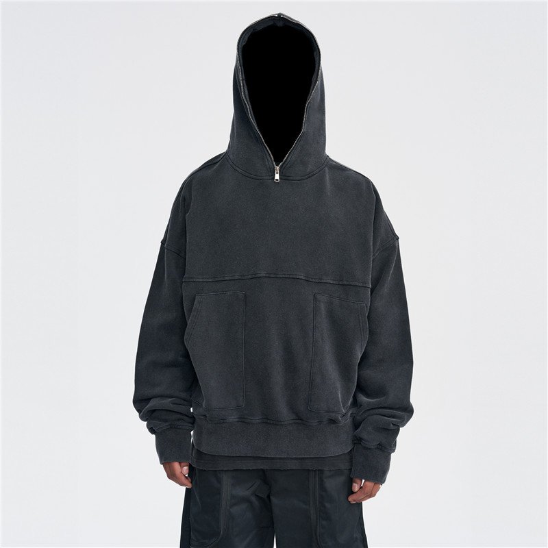 Man wearing a dark gray washed oversized half-zip pullover hoodie
