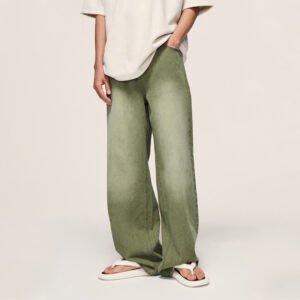 Person wearing washed loose-leg green denim jeans